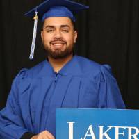 man at GradFest with laker for a lifetime sign